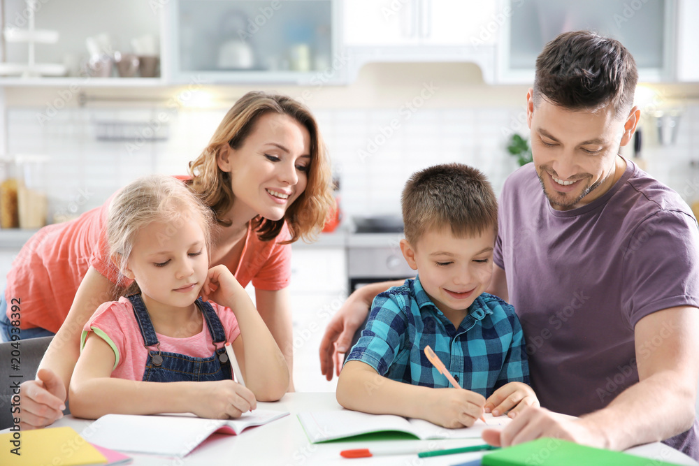Little children with parents doing homework at home Little children with parents doing homework at home