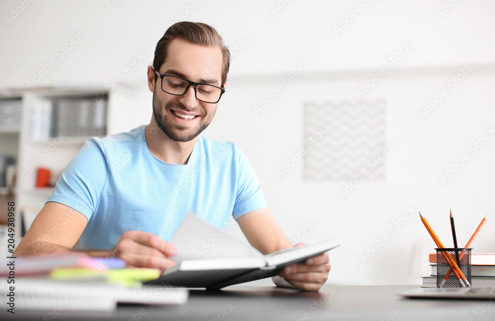 Student studying at table indoors Student studying at table indoors