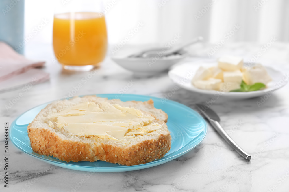 Fresh bread with tasty butter on plate Fresh bread with tasty butter on plate