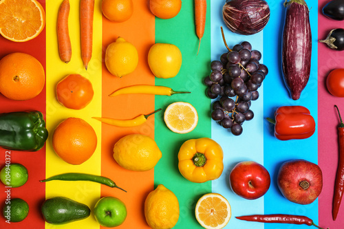 Fototapeta Naklejka Na Ścianę i Meble -  Rainbow composition with fresh vegetables and fruits on color background, flat lay
