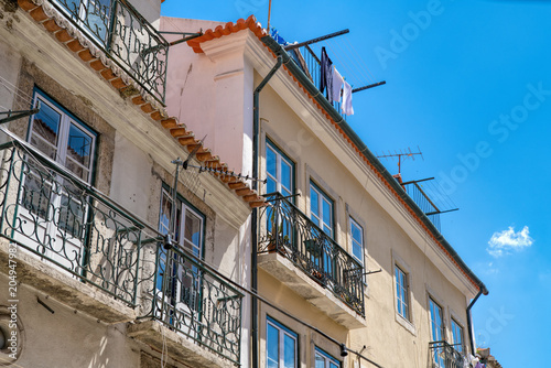 Aged vintage building facade with balcony. Vintage building facade wall. Classic European architecture. © Kalnenko