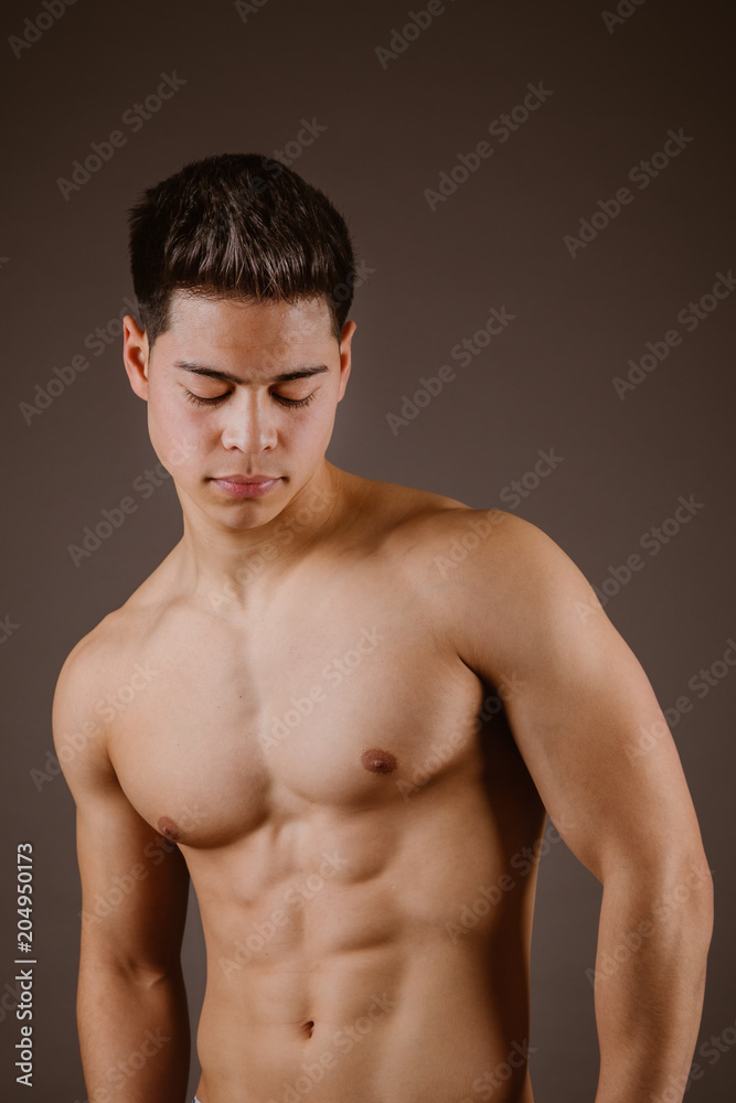 Muscular man posing on dark background Muscular man posing on dark background