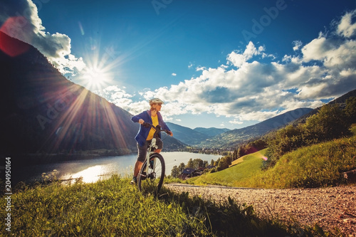 woman on e-bike enjoying view to a beautiful lake