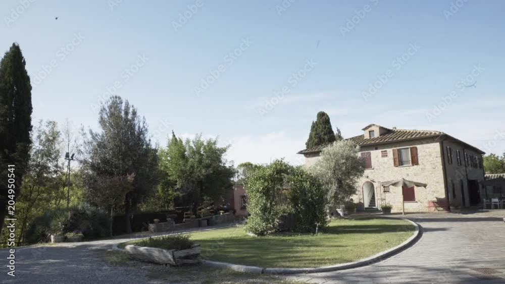 Pan right, fancy driveway to house Pan right, fancy driveway to house