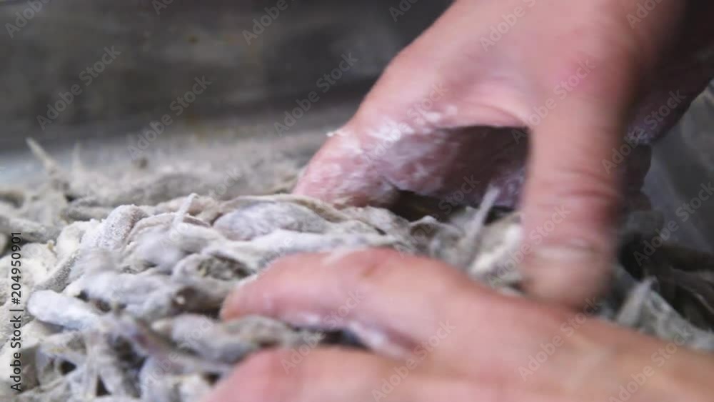Mixing flour with anchovies, close up Mixing flour with anchovies, close up