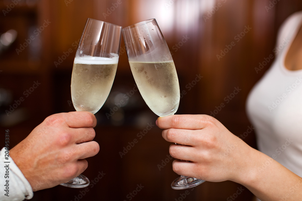 Couple toasting glasses of champagne