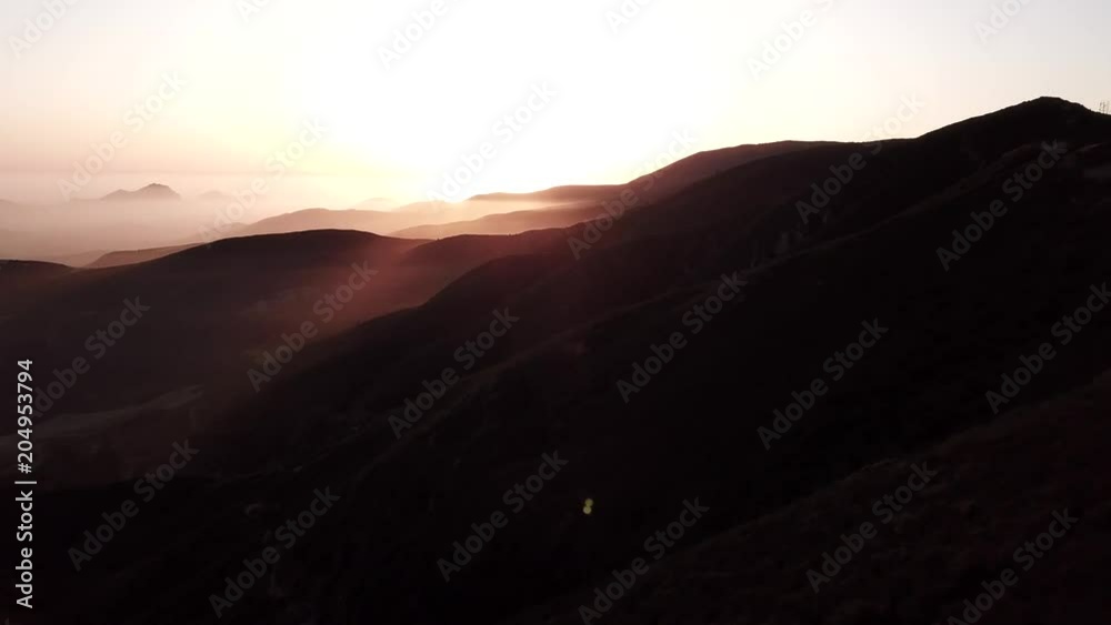 aerial view flying over the mountains and dusk with sunset aerial view flying over the mountains and dusk with sunset