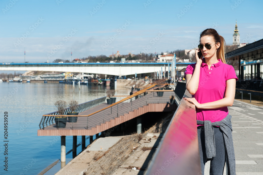Woman On Bridge Talking On Cell Phone