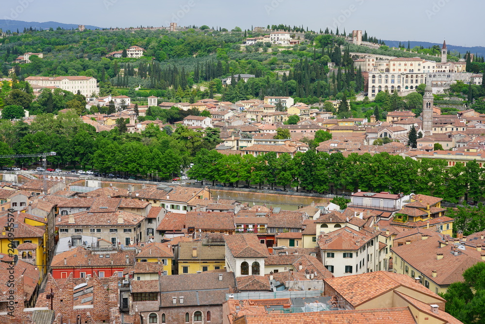 View of buildings and roofs in the old city of Verona, Italy, seen from the top of the Torre dei Lamberti tower