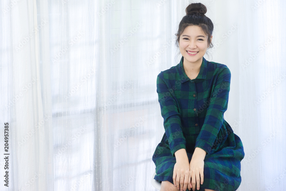 Happy cheerful young woman looking at camera with joyful and charming smile Happy cheerful young woman looking at camera with joyful and charming smile