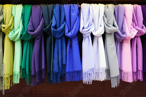 Colorful hanging display of wool scarves  photo