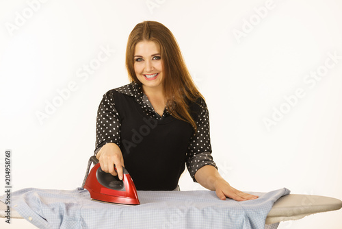 Happy woman doing ironing