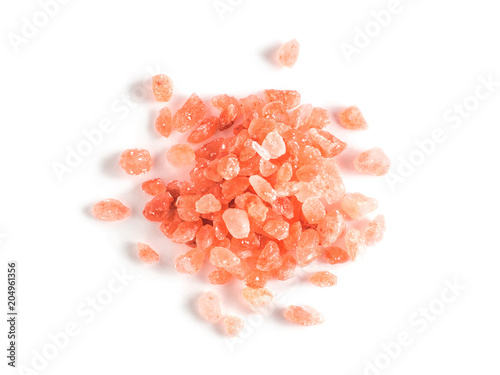 Himalayan pink salt in crystals on white background. Heap of pink salt isolated with clipping path. Top view or flat-lay.