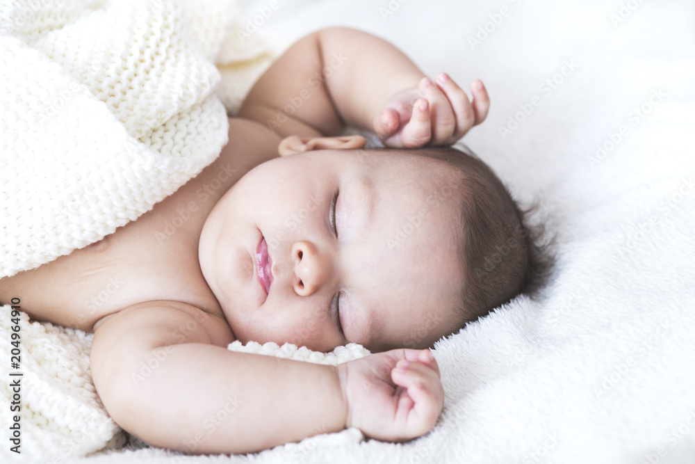Close up portrait of sleeping sweet baby boy in a bright bedroom covered with white blanket. Love, cheerful, mother's care. Close up portrait of sleeping sweet baby boy in a bright bedroom covered with white blanket. Love, cheerful, mother's care.