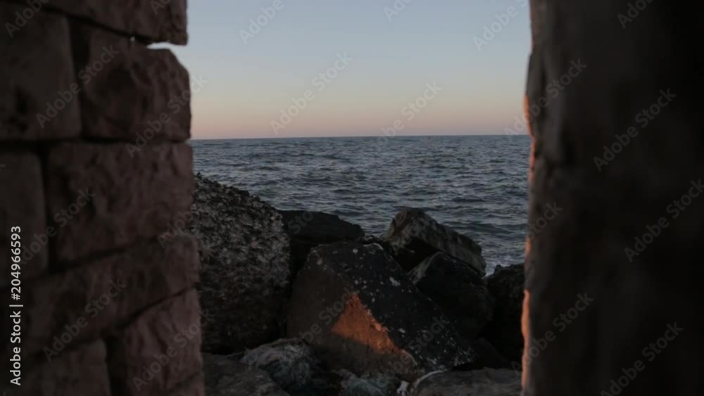 Tracking shot, rocky coast at sunset Tracking shot, rocky coast at sunset