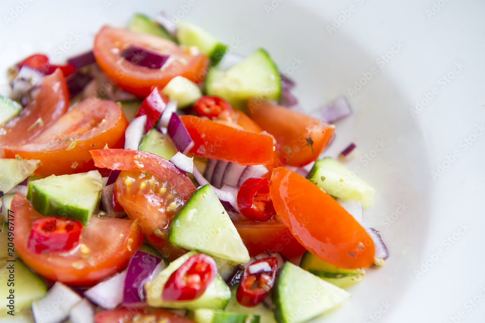 Close-up abstract view of Turkish shepherd's salad of tomato, cucumber, onion and pepper