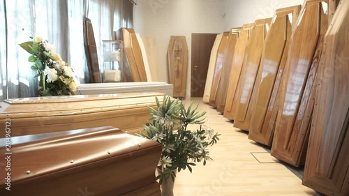 Trucking shot, coffins in funeral home