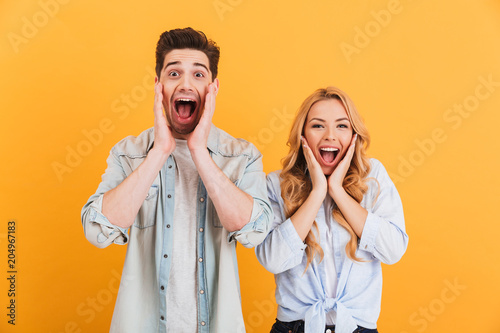 Slika na platnu Image of ecstatic people man and woman in basic clothing screaming in surprise o