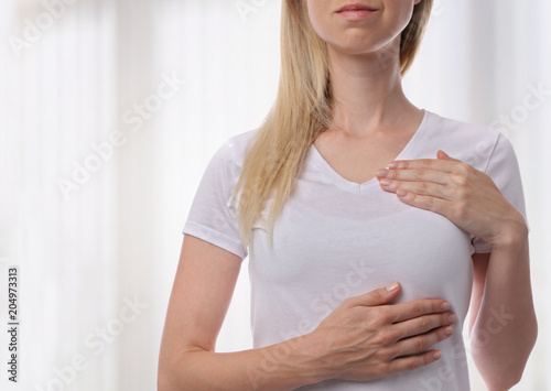 Woman Checking Her Breast, health care and prevention concept photo