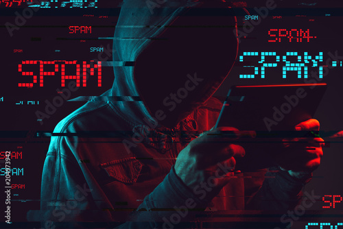 Electronic spamming concept with faceless hooded male person photo