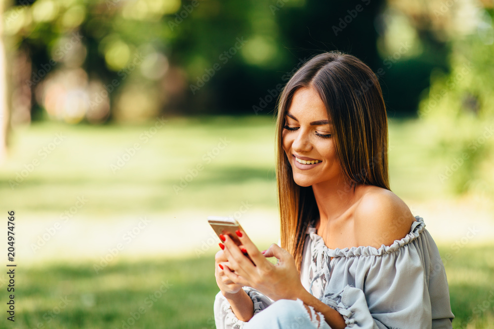 Young woman using a smartphone in the park
