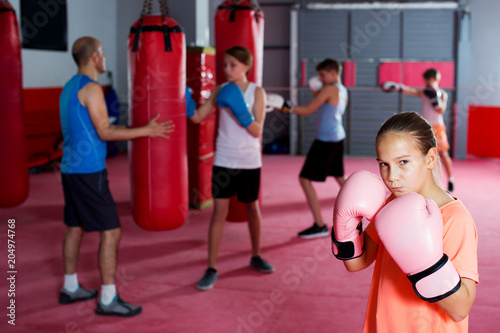 Girl with boxing gloves posing in defended stance © JackF