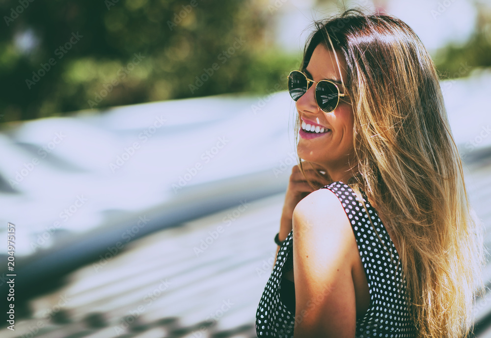 Naklejka premium Young beautiful woman wearing sunglasses outdoor. Vintage nostalgia photo