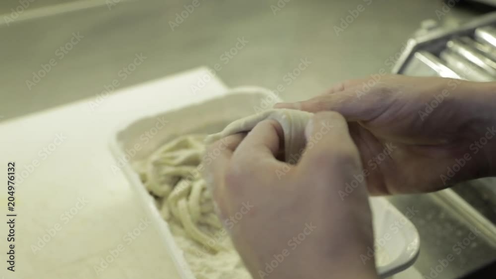Close up, chef separates pasta dough Close up, chef separates pasta dough