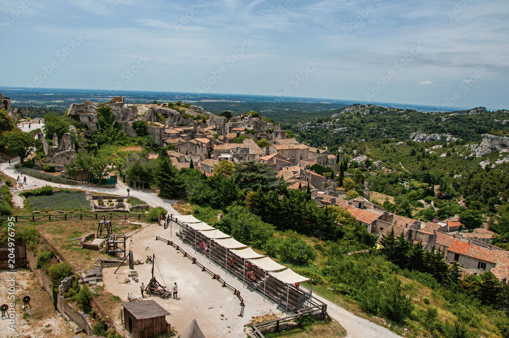 Panoramic view of the Baux-de-Provence castle ruins on the hill, with the roofs of the village just below. Bouches-du-Rhone department, Provence-Alpes-Côte d'Azur region, southeastern France