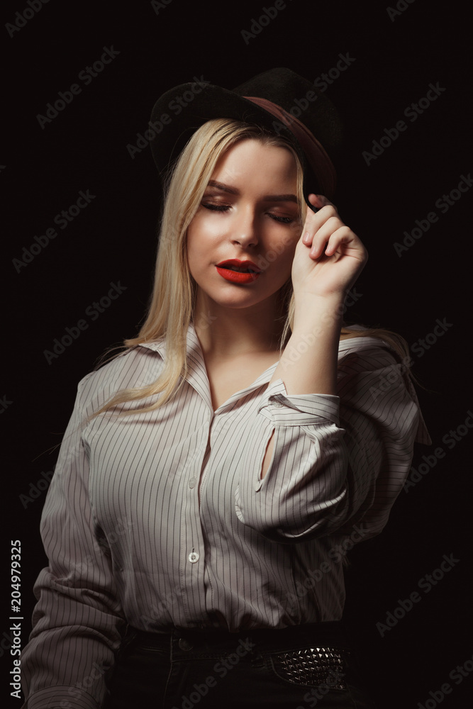 Amazing blonde girl in glasses and hat, posing with dramatic light at studio Amazing blonde girl in glasses and hat, posing with dramatic light at studio