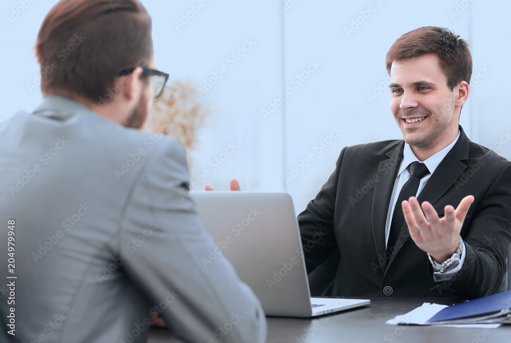 employees of the company talking at his workplace employees of the company talking at his workplace