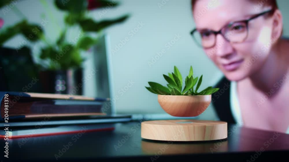 4K Woman Looking at Levitation Device in Corporate Office 4K Woman Looking at Levitation Device in Corporate Office