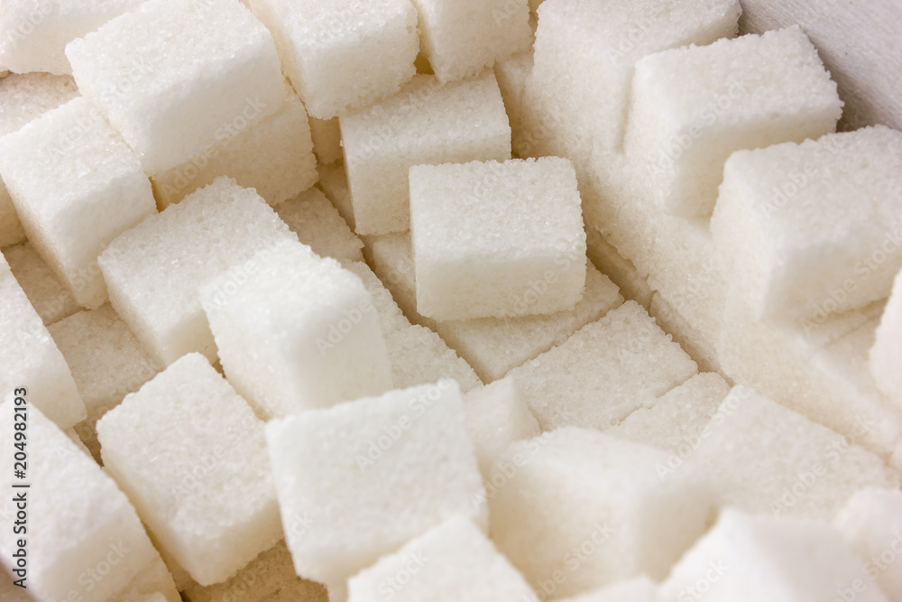 Cubes of sugar on a white background. Many cubes of sugar close-up. Cubes of sugar on a white background. Many cubes of sugar close-up.