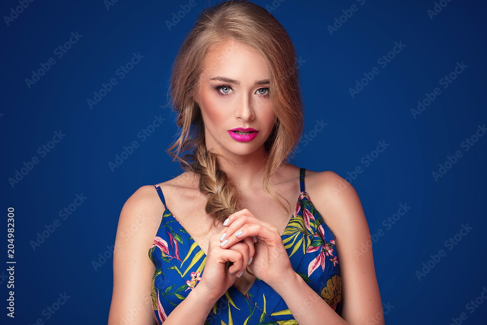 Beautiful blonde girl with braid and glamour makeup.
