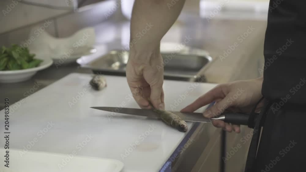 Chef cuts fish, close up Chef cuts fish, close up