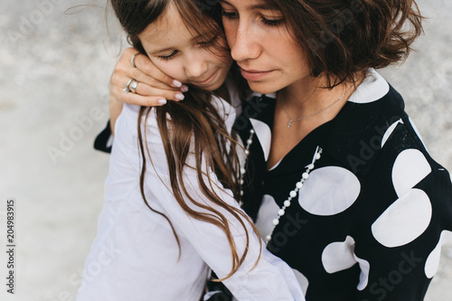 portraits of mom and daughter on the sea beach