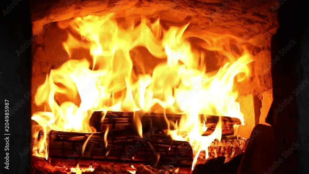 Firewood and fire flames in fireplace, bonfire close-up, 4K UHD.
Firewood and fire flames in fireplace, bonfire close-up, 4K UHD.