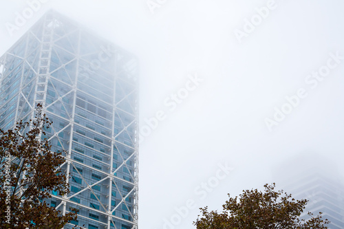 Office buildings of Gas Natural fenosa is a Spanish natural gas utilities company. The firm is headquartered located in Barcelona. Foggy skyscrapers.