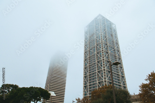 Office buildings of Gas Natural fenosa is a Spanish natural gas utilities company. The firm is headquartered located in Barcelona. Foggy skyscrapers.
