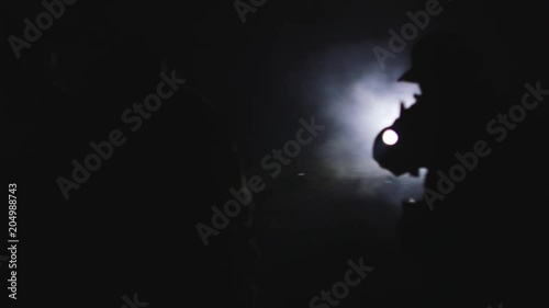 Platoon of soldiers at night with weapons drawn