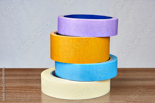 Obraz na płótnie Four multi-colored adhesive tapes are stacked one above the other