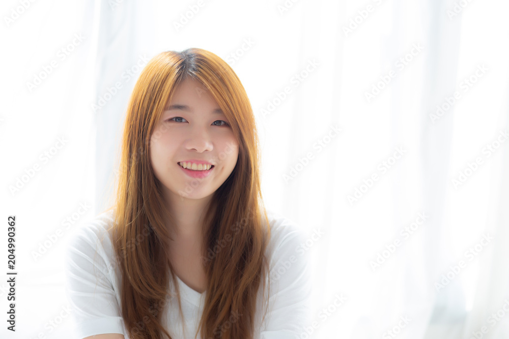 Portrait of beautiful young asian woman standing the window and smile while wake up with sunrise at morning, lifestyle and relax concept. Portrait of beautiful young asian woman standing the window and smile while wake up with sunrise at morning, lifestyle and relax concept.