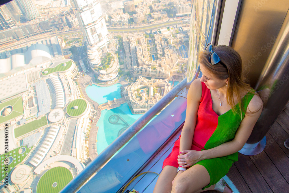 1000px x 667px - Beautiful sexy girl sitting by the window in Dubai Burj Khalifa tower with  an amazing panoramic view over the city and fountains. Stock Photo | Adobe  Stock