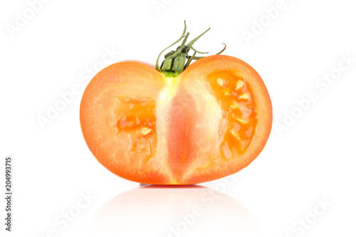 One red tomato section half with seeds isolated on white background. photo