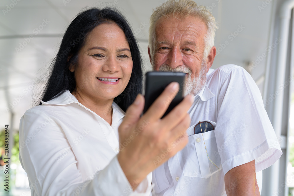 Obraz premium Mature multi-ethnic couple happy and in love while exploring the