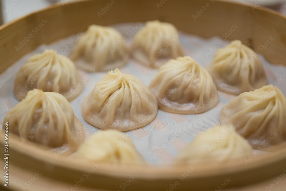Traditional pork Xiaolongbao dumpling in a bamboo basket Traditional pork Xiaolongbao dumpling in a bamboo basket
