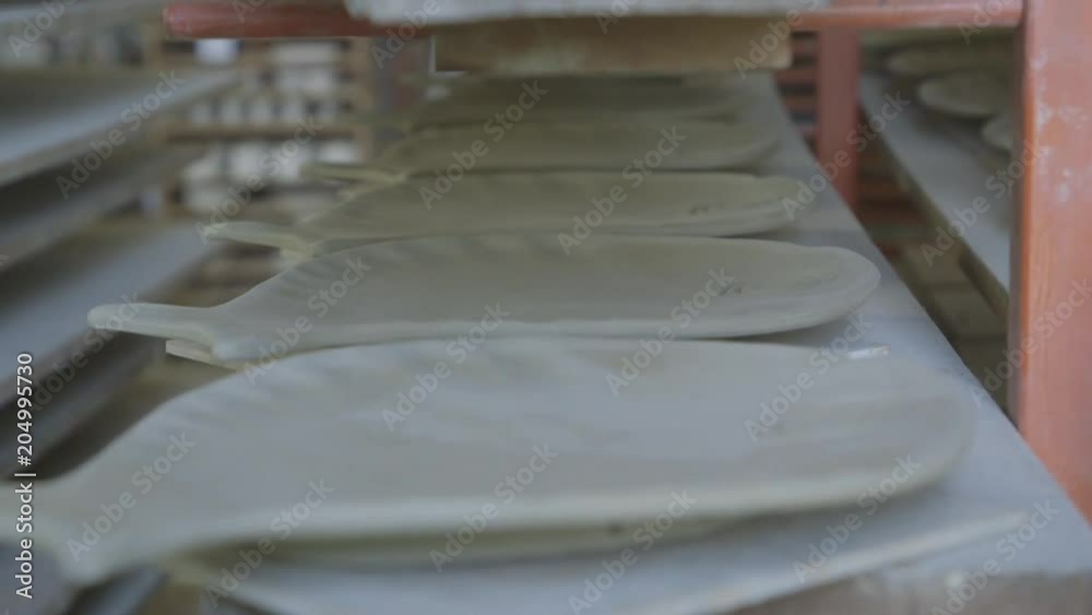 Designer clay plates on shelves, close up Designer clay plates on shelves, close up