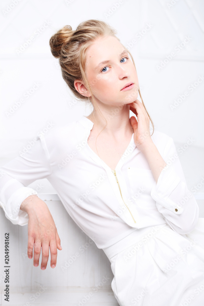 Children's fashion. Beautiful pensive serious blonde girl in white clothes. Children's fashion. Beautiful pensive serious blonde girl in white clothes.