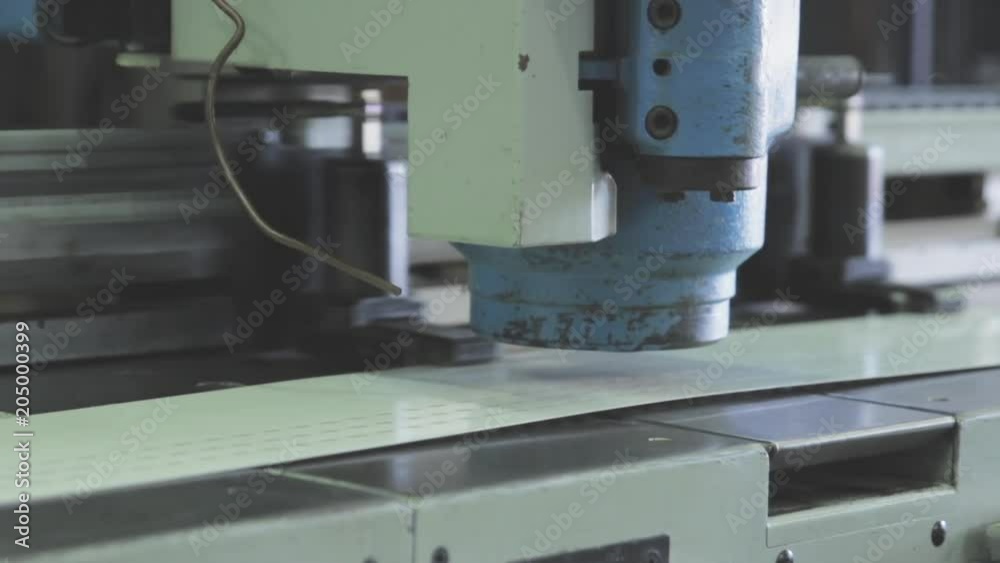 Machine presses metal in factory, close up Machine presses metal in factory, close up