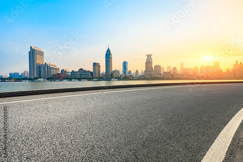 empty asphalt road and historic building scene at sunset in shanghai
